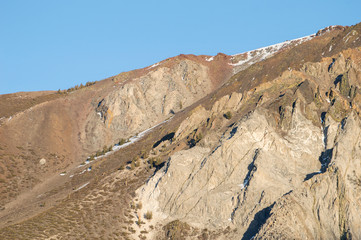 Red mountains with melting snow