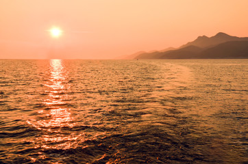 Sunset behind the Mljet island in Croatia, Europe. Mljet island from a sailboat.
