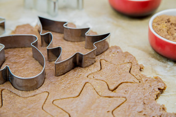 Cutting out Christmas cookies with cookie cutters