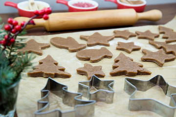 Fototapeta na wymiar Cutting out Christmas cookies with cookie cutters