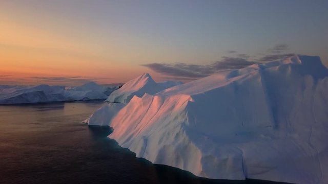 Icebergs in Greenland, sunset aerial