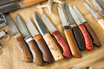 Foto auf Leinwand hunting knives on the table © Andrey