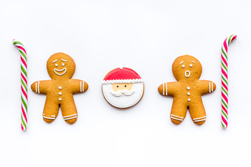 Gingerbread man cookies for New Year meal on white background top view