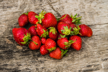 Ripe fresh strawberries on rustic wooden background. Top view