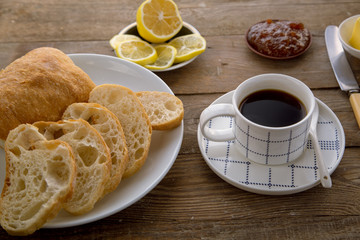 Breakfast with traditional French bread and cup of coffee.