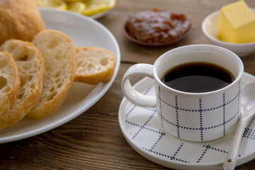 Breakfast with traditional French bread and cup of coffee.