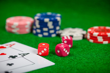 Dice on casino gamble table. Poker chips and banknotes on table in casino