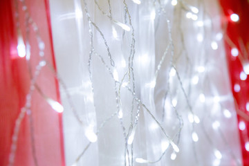 Fototapeta na wymiar Christmas garland on the curtain