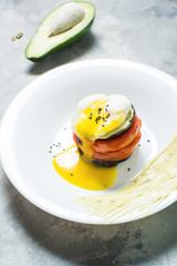 Eggplant, Tomato and egg Stacks on plate. Concrete background.