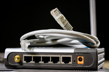 Network hub and rj45 cables on the stage. Computer accessories used in networking.