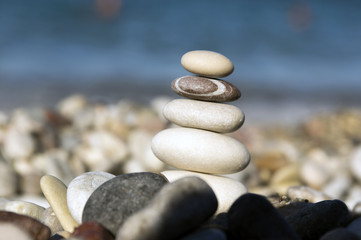 Fototapeta na wymiar Stones and pebbles stack, harmony and balance, one stone cairn on seacoast