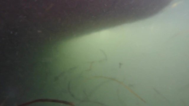 An underwater shot of a large ocean fishing boatin water