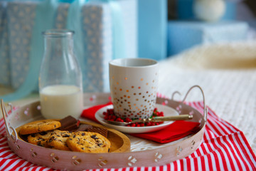 cookies, milk, gift box on white tray