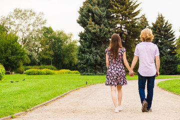 Obraz premium Man and woman holding hands in park