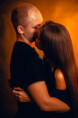 Girl and boy on the background of a sunset color