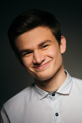 young brunette guy in a white shirt