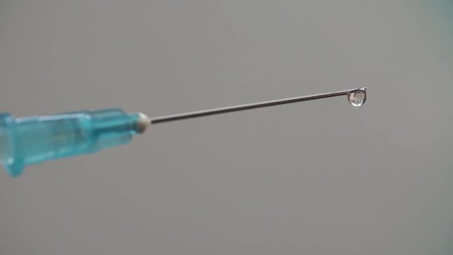 Medical syringe with drugs on blurry background