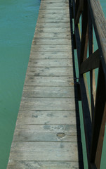 long wooden walkway suspended above the water without people