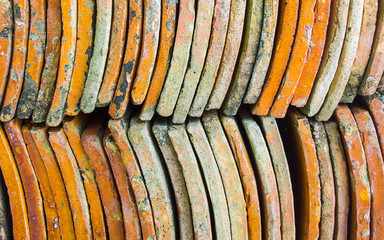 Old colored clay roof tile put in the stack, abstract, texture, pattern