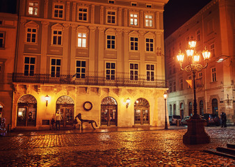 city night street paving stone bench