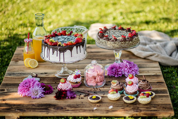 selection of tasty desserts and cakeson old wood background