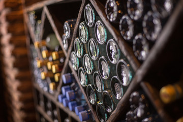 cupboard of bottles of wine winebottles warehouaw cellar