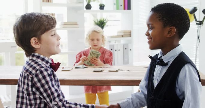 Kids as business executives shaking hands 
