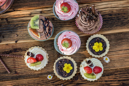 selection of tasty desserts and cakeson old wood background
