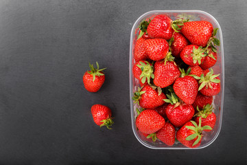 Strawberries in plastic box, top view