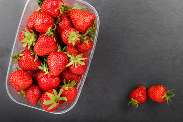 Strawberries in plastic box, top view