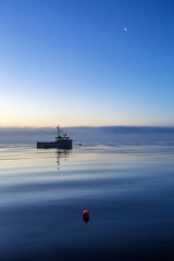 Boat calm sunrise moon is up