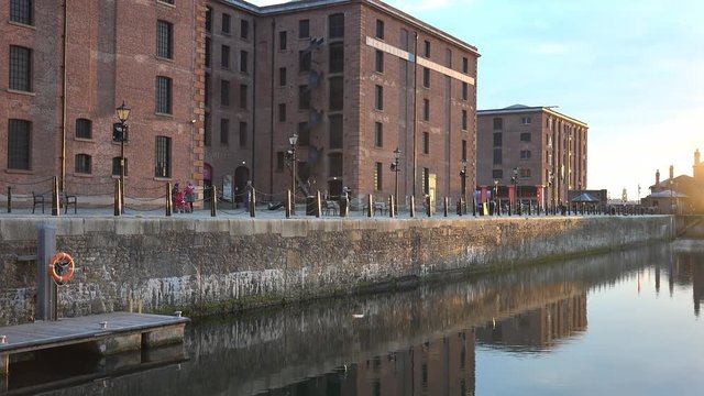 4k Albert docks in Liverpool, with reflection of victorian buildings in water