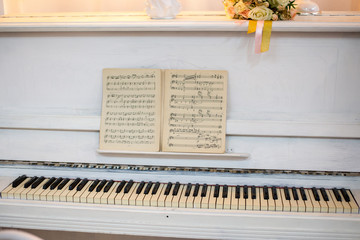 White piano with notes