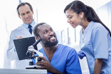 Fototapeta premium Team of professionals. Joyful nice smart doctors being in the lab and working together while being a team