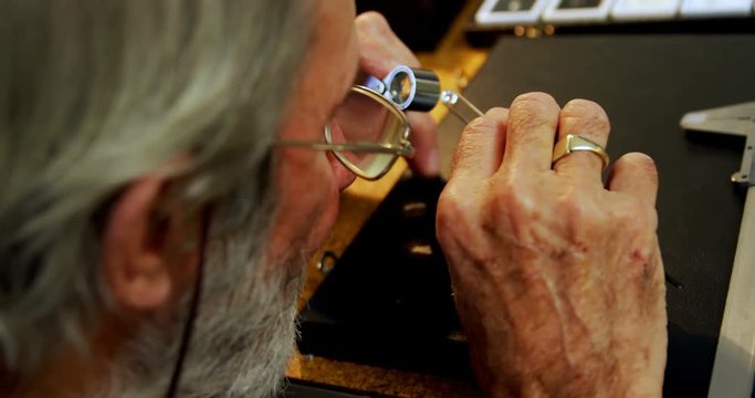 Goldsmith examining diamond 