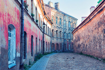 Street with old houses and cobblestone in Old City Vilnius