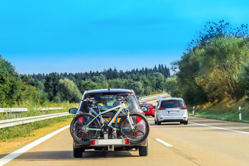 Car with bicycles in highway in Switzerland