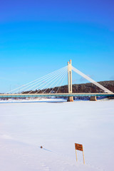 Obraz premium Candle bridge and blue sky in snow covered Rovaniemi