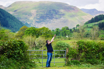 Man enjoying chain of mountains in Snowdonia National Park UK