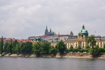 Fototapeta na wymiar Vltava River embankment with Prague Old Town Strakova Academy