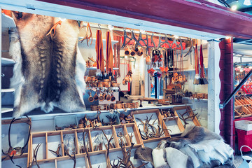 Fototapeta na wymiar Market counter with reindeer skin and horns in winter Rovaniemi