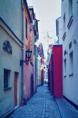 Illuminated street with lanterns in Old Town of Riga
