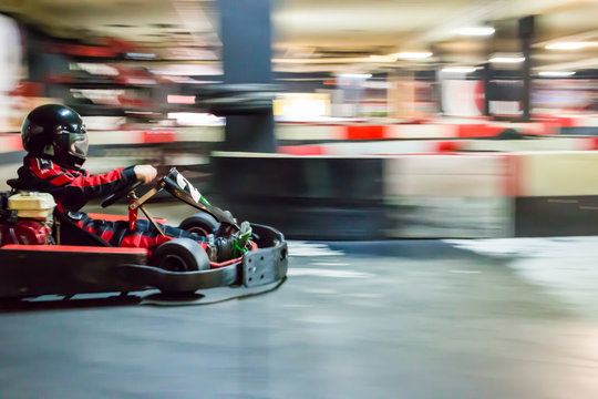 Cart blurred by high speed, a boy having fun - driving fast, racing, speeding. 