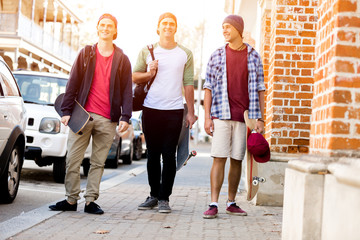 Fototapeta premium Teenage friends walking at the street