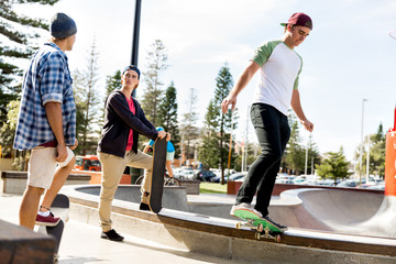 Fototapeta premium Teenage boys skateboarding outdoors