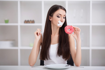 Diet. The concept of healthy and unhealthy nutrition. The model plus size makes a choice in favor...