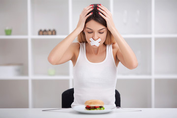 Diet. The concept of healthy and unhealthy nutrition. The model plus size makes a choice in favor...