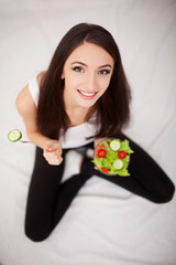 Diet. The concept of healthy and unhealthy nutrition. The model plus size makes a choice in favor...