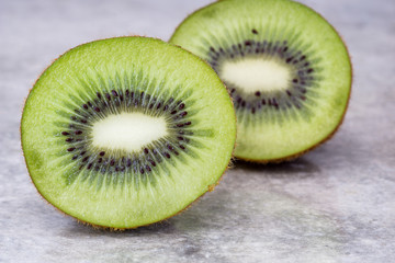 Fototapeta premium Half of juicy kiwi fruit on background.