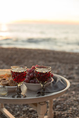 romantic dinner with wine and grapes by seaside